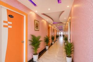 an office hallway with potted plants in a corridor at Triotel Inn in Dhanbād