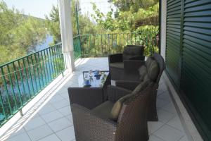 a patio with two chairs and a table on a balcony at Apartment Nono Ivo in Vis
