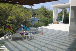 a patio with two chairs and a table and a fence at Apartment Nono Ivo in Vis
