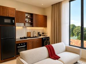 a living room with a couch and a kitchen at Mia Bella Madre Morogoro in Morogoro