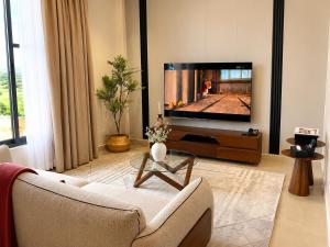 a living room with a couch and a tv at Mia Bella Madre Morogoro in Morogoro