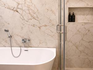 a bathroom with a shower and a bath tub at Mia Bella Madre Morogoro in Morogoro +14 photos