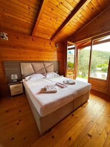 a bedroom with a large bed in a wooden room at Casa Mila apartments & bungalows in Ulcinj +152 photos