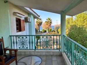 a balcony of a house with a view of a street at Gate to the blue in Áyioi Apóstoloi