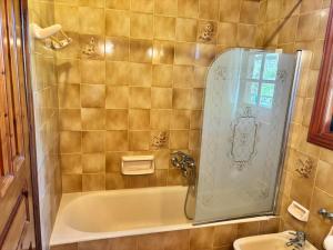 a bathroom with a shower and a bath tub at Gate to the blue in Áyioi Apóstoloi +73 photos