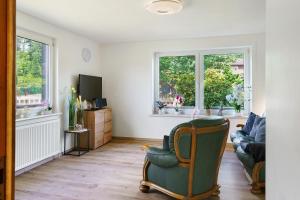 a living room with a couch and a chair at Lärche in Sprakensehl