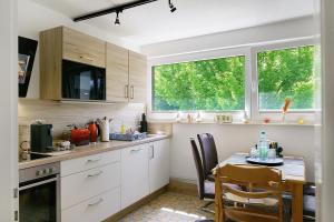 a kitchen with a table and a dining room at Lärche in Sprakensehl
