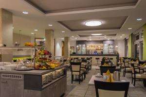 a restaurant with tables and chairs and a buffet at Hotel Fortuna in Schwäbisch Gmünd