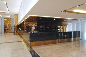 a lobby with a counter in the middle of a building at Hermann Hotel Pattaya in Pattaya +234 photos