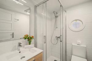 a white bathroom with a shower and a sink at Oasis Garden, Alegranza in Chayofa +23 photos