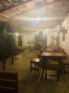 a room with a table and benches in it at Early birds in Arugam Bay