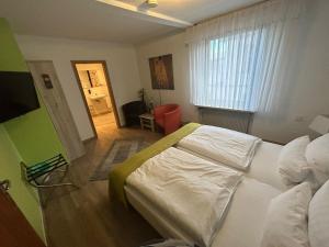 a bedroom with a large white bed in a room at Hotel Deutsches Haus in Lampertheim