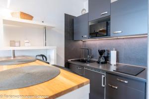 a kitchen with a sink and a counter top at Waterkant in Schilksee