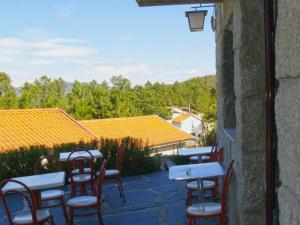 a group of tables and chairs on a patio at A Cobiça do Mundo in Pincães