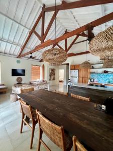 a large dining room with a wooden table and chairs at Captain Goodtimes in Gili Islands