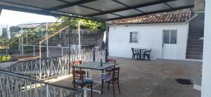 a patio with a table and chairs on a balcony at Apartman Metovic in Bar +5 photos