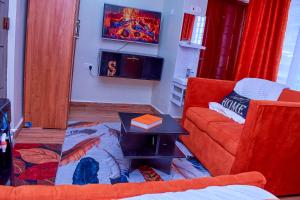 a living room with a couch and a table at Branson Comfort Inn in Kakamega +5 photos