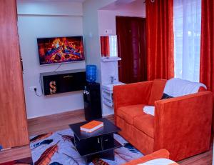 a living room with a couch and a fire place at Branson Comfort Inn in Kakamega
