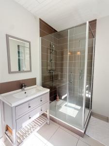 a bathroom with a glass shower and a sink at La maison du lac in Vions +29 photos