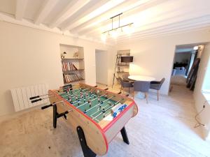 a room with a foos ball on a table at La maison du lac in Vions