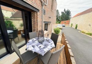 a table and chairs on the balcony of a house at Le Grainetier in Margny-lès-Compiègne