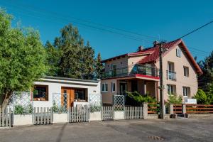 a house with a white fence at gardenSTUDIO in Děčín