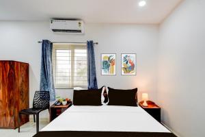 a bedroom with a white bed and a window at Super Townhouse Nallagandla Nest in Hyderabad +22 photos