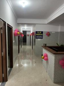 a hallway with pink balloons in a building at S L N paradise in Chik Bānavar