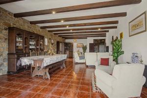 a living room with white chairs and a table at Casa Da Redouça in Cedrim