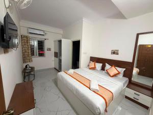 a bedroom with a large bed and a television at S L N paradise in Chik Bānavar +24 photos