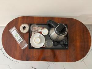 a table with a tray with dishes and a tea pot at S L N paradise in Chik Bānavar