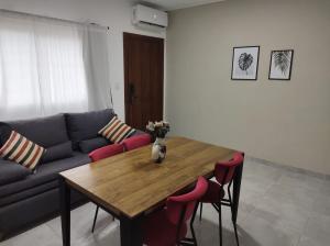 a living room with a table and a couch at Departamento Alquiler Temporal en Chascomús in Chascomús