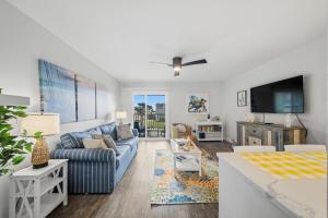 a living room with a couch and a tv at Carolina Beach Ocean Playground in Carolina Beach