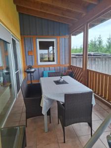 a porch with a table and chairs on a balcony at Ferienwohnung Heck in Waldeck