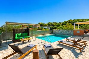 a patio with chairs and a swimming pool at Villa Canova in Mesovoúnia