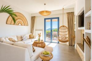 a living room with a couch and a table at Villa Canova in Mesovoúnia