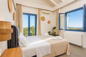 a bedroom with a bed and a large window at Villa Canova in Mesovoúnia +19 photos