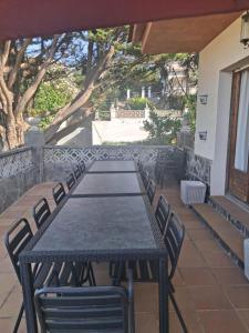 a black table and chairs on a patio at Villa Ingrid Costa Brava in Vidreres
