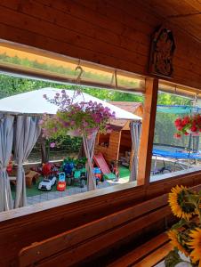 a view of a patio with an umbrella and a playground at Casa Inna Inna Corbu in Corbu