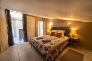 a bedroom with a bed and a large window at Soleil de Provence in Nyons