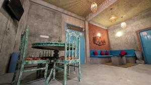 a room with a table and chairs and a couch at Soul Villas in Tangalle