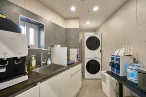 a kitchen with a sink and a dishwasher at Seoul Jongno Hostel in Seoul +60 photos
