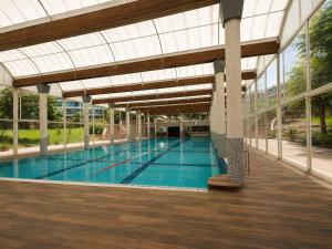a large swimming pool with a glass ceiling at ODAR suite in Caesarea