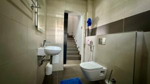 a bathroom with a toilet and a sink and stairs at Villa La Lagune in Mbour +27 photos