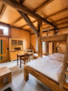 a bedroom with a large bed and a table at Férovka in Jeseník