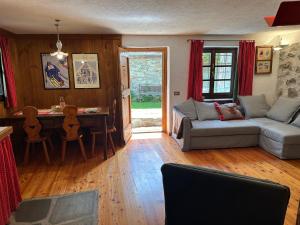 a living room with a couch and a table at Baita Meyen - Val Ferret in Courmayeur