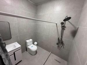 a small bathroom with a toilet and a sink at Вип Вилла у берега in Chon-Sary-Oy