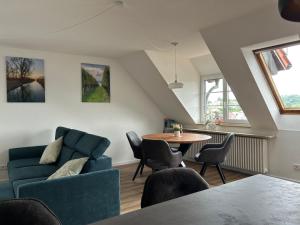 a living room with a blue couch and a table at Loggia in Stockach