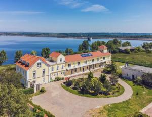 an aerial view of a large house with a lake at Holiday Centrum in Žatec