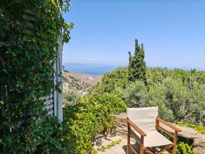 a chair sitting on top of a hill at The Ioulis Pool in Ioulis